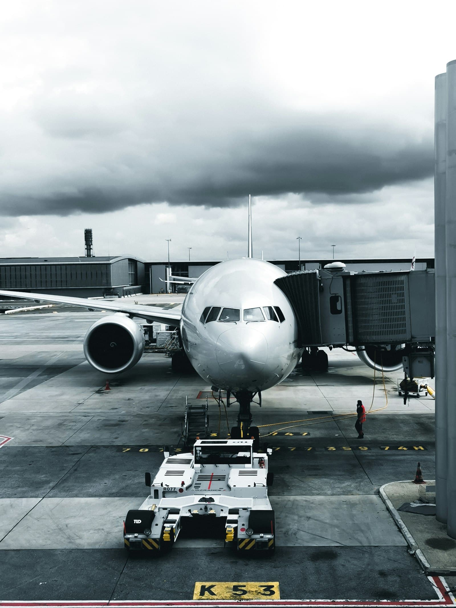 Airliner at the gate with a pushback tug and ground crew